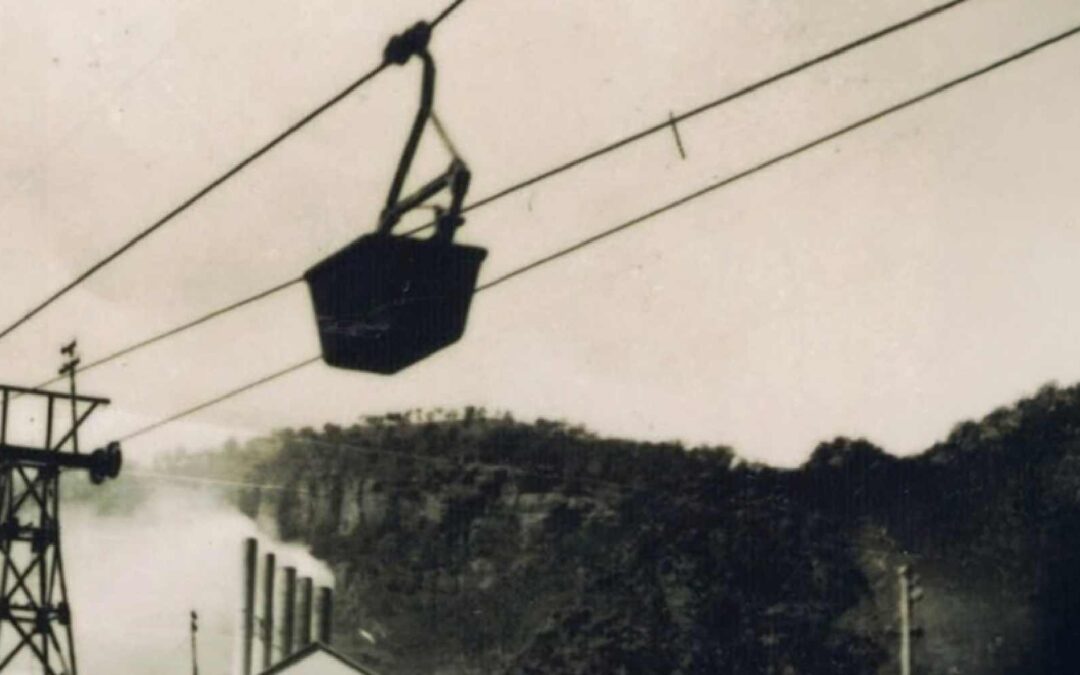 Ropeways mountain energy infrastructure showing cable bucket system, pylons, and rugged hillside industrial landscape.